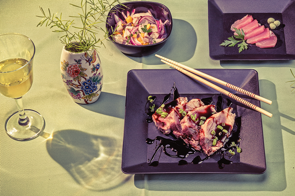 Foto de uma mesa de refeição com comida asiática servida em um prato 