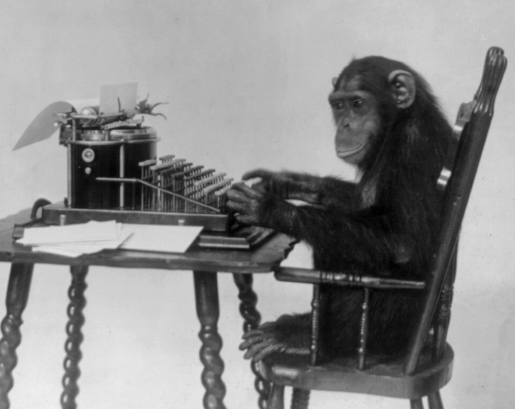 Chimpanzee_seated_at_typewriter Chimpanzee_seated_at_typewriter