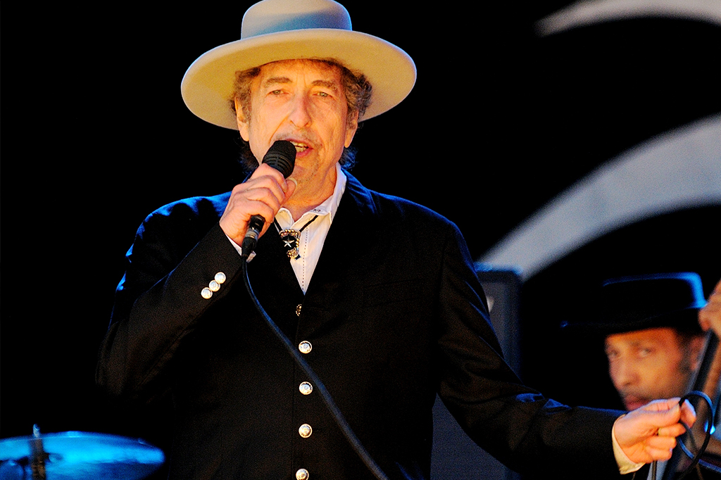 SI_bob-dylan_site Bob Dylan em show, segurando microfone.